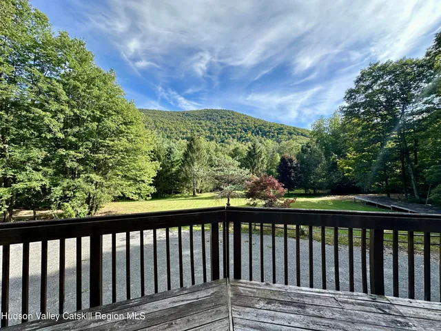 a view of a house with a wooden deck