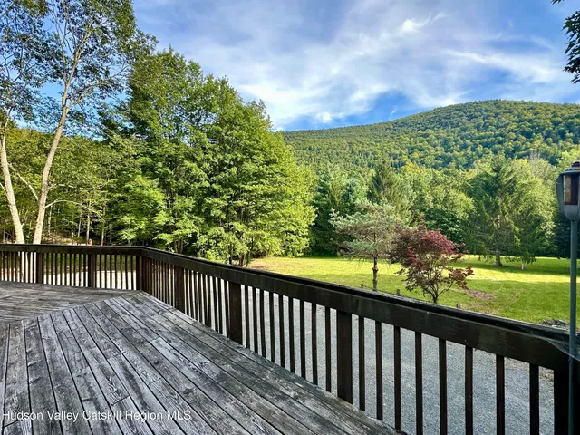 an outdoor view of a house with backyard porch and sitting area