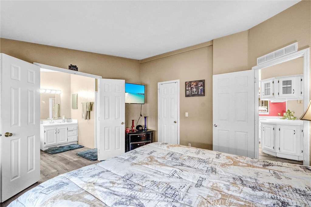 1051 Site Drive, Unit 51 Brea, CA 92821 - Photo 24 of 32 a bedroom with a bed and a cabinets