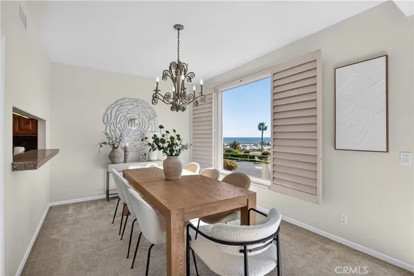 a view of a dining room with furniture wooden floor and chandelier