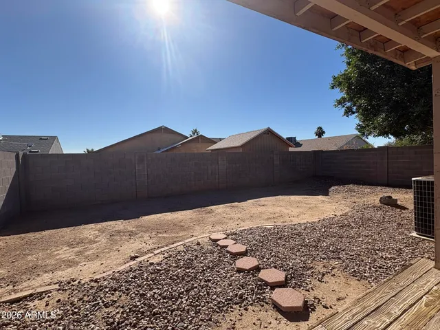 a view of a white house with a yard