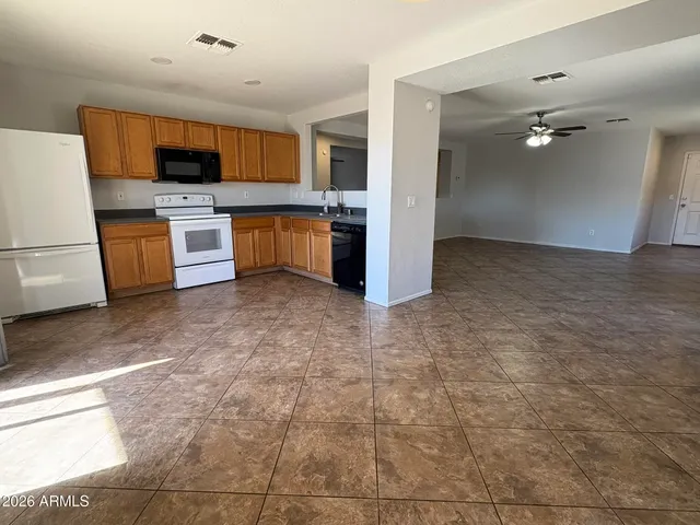 a kitchen with stainless steel appliances a stove a sink and a refrigerator