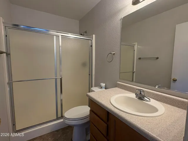 a bathroom with a sink toilet and a mirror