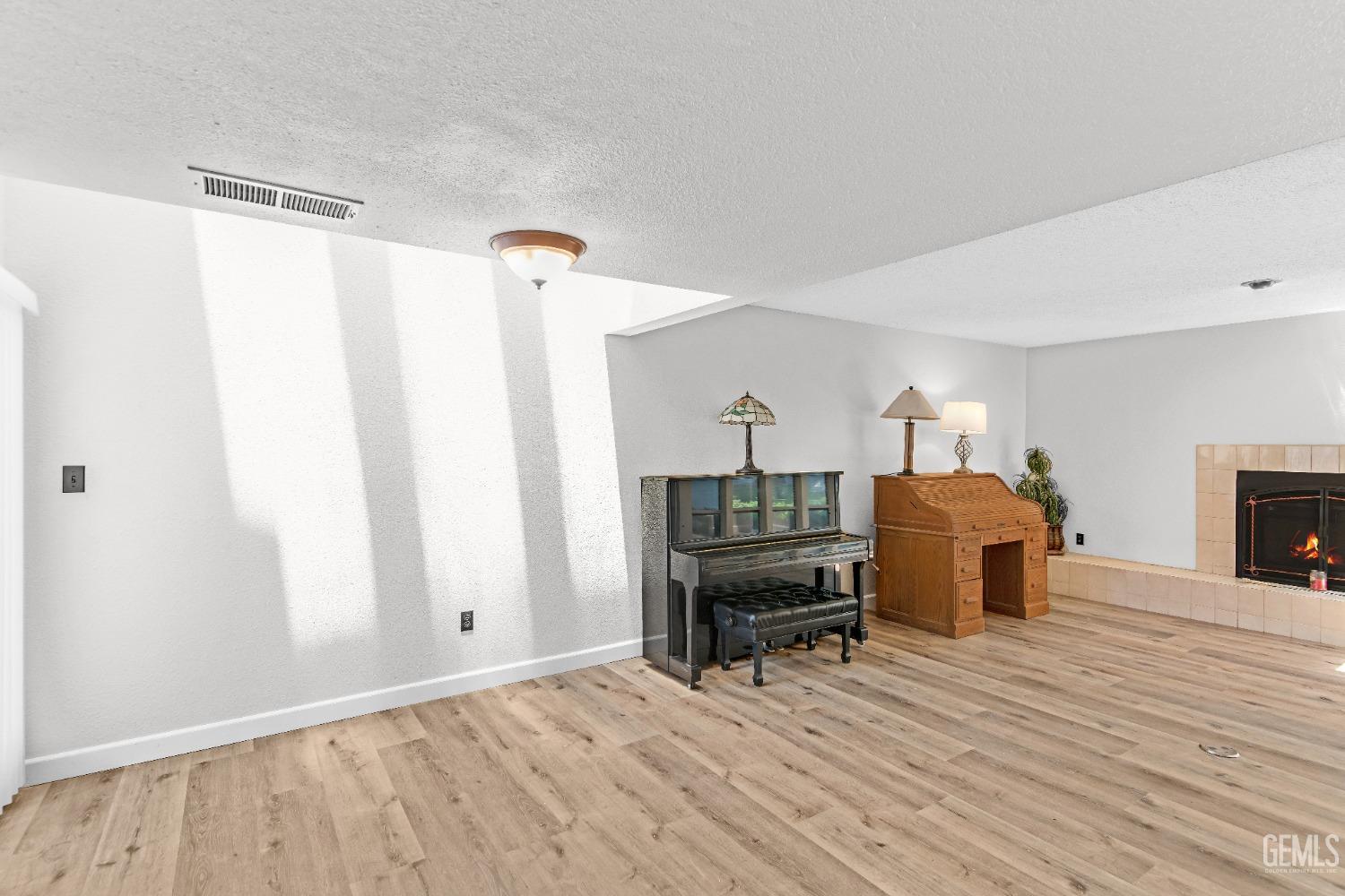 Undisclosed Address Bakersfield, CA 93309 - Photo 18 of 38 a living room with furniture and a wooden floor