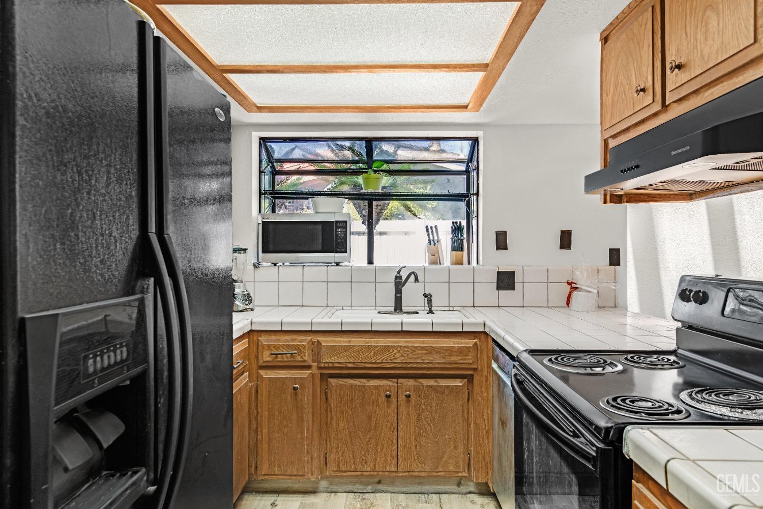 Undisclosed Address Bakersfield, CA 93309 - Photo 19 of 38 a kitchen with stainless steel appliances granite countertop a sink stove and refrigerator
