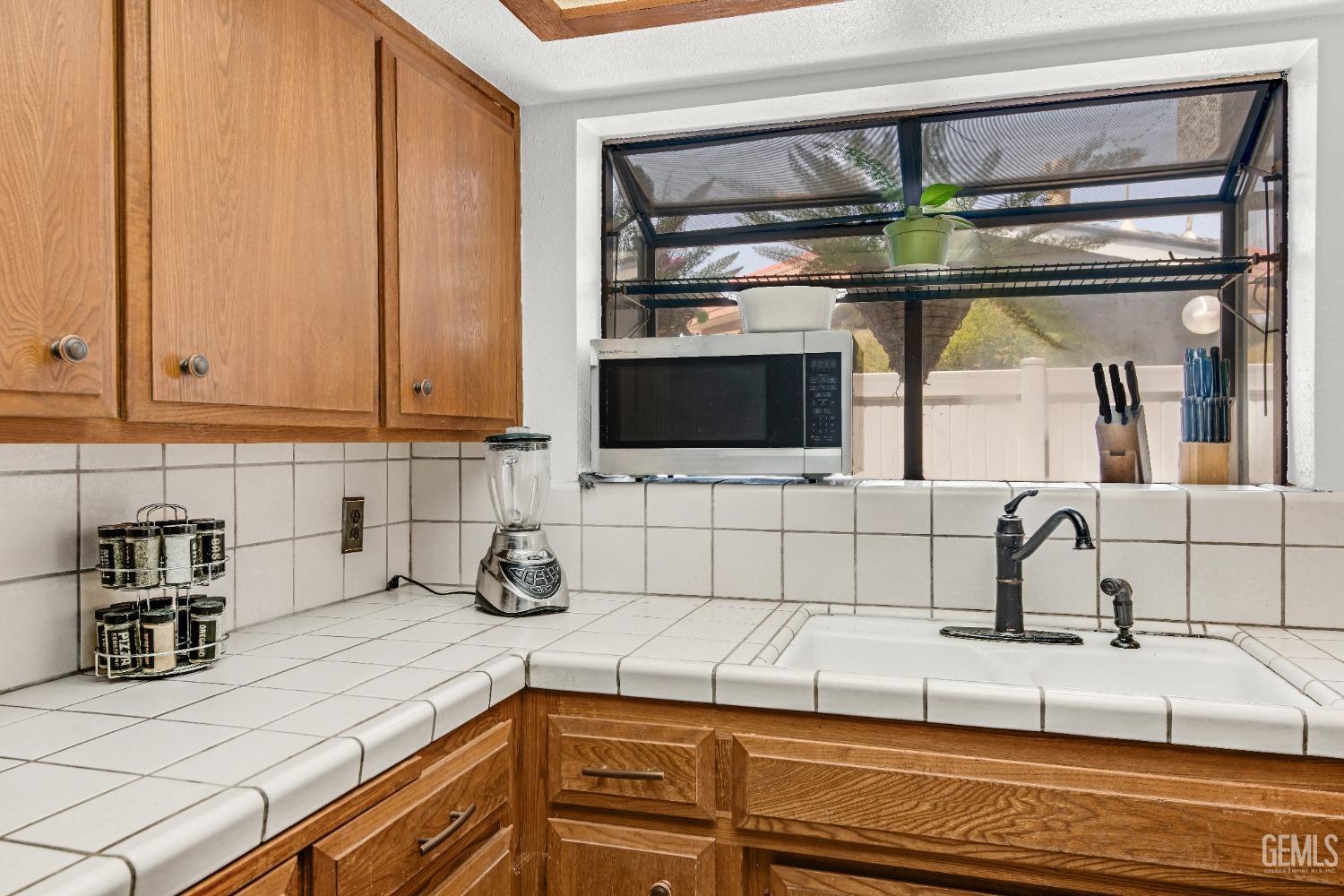 Undisclosed Address Bakersfield, CA 93309 - Photo 21 of 38 a kitchen with a sink and cabinets
