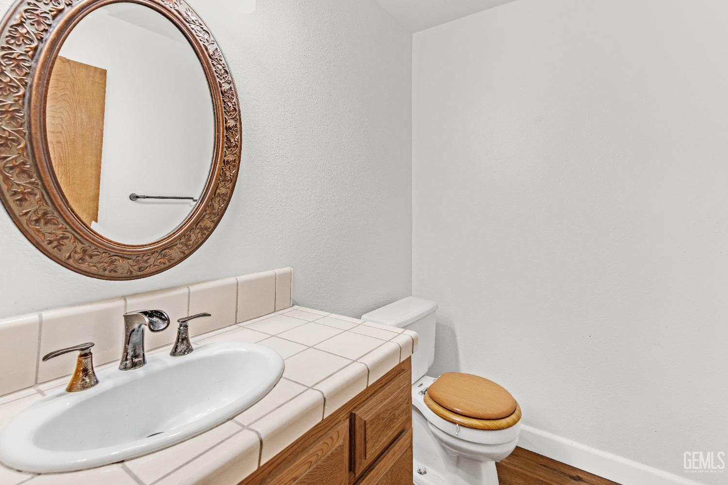 Undisclosed Address Bakersfield, CA 93309 - Photo 22 of 38 a bathroom with a sink and a mirror