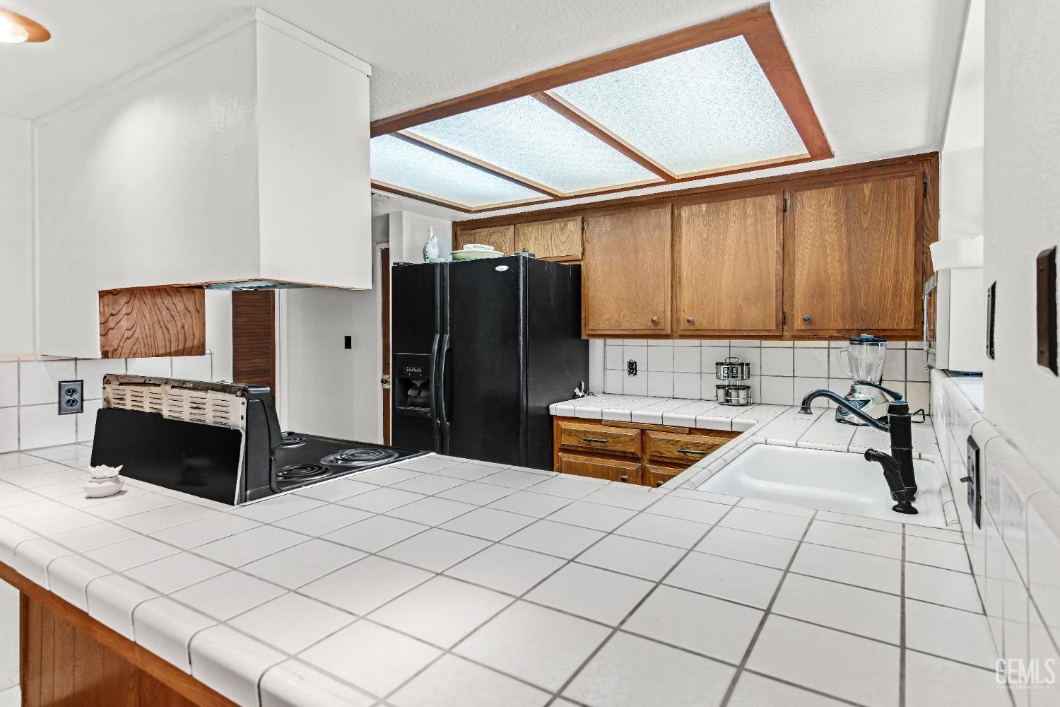 Undisclosed Address Bakersfield, CA 93309 - Photo 23 of 38 a kitchen with stainless steel appliances kitchen island granite countertop a refrigerator and a stove top oven