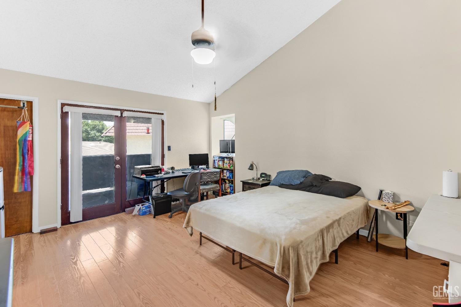 Undisclosed Address Bakersfield, CA 93309 - Photo 25 of 38 a bedroom with double bed and a chandelier