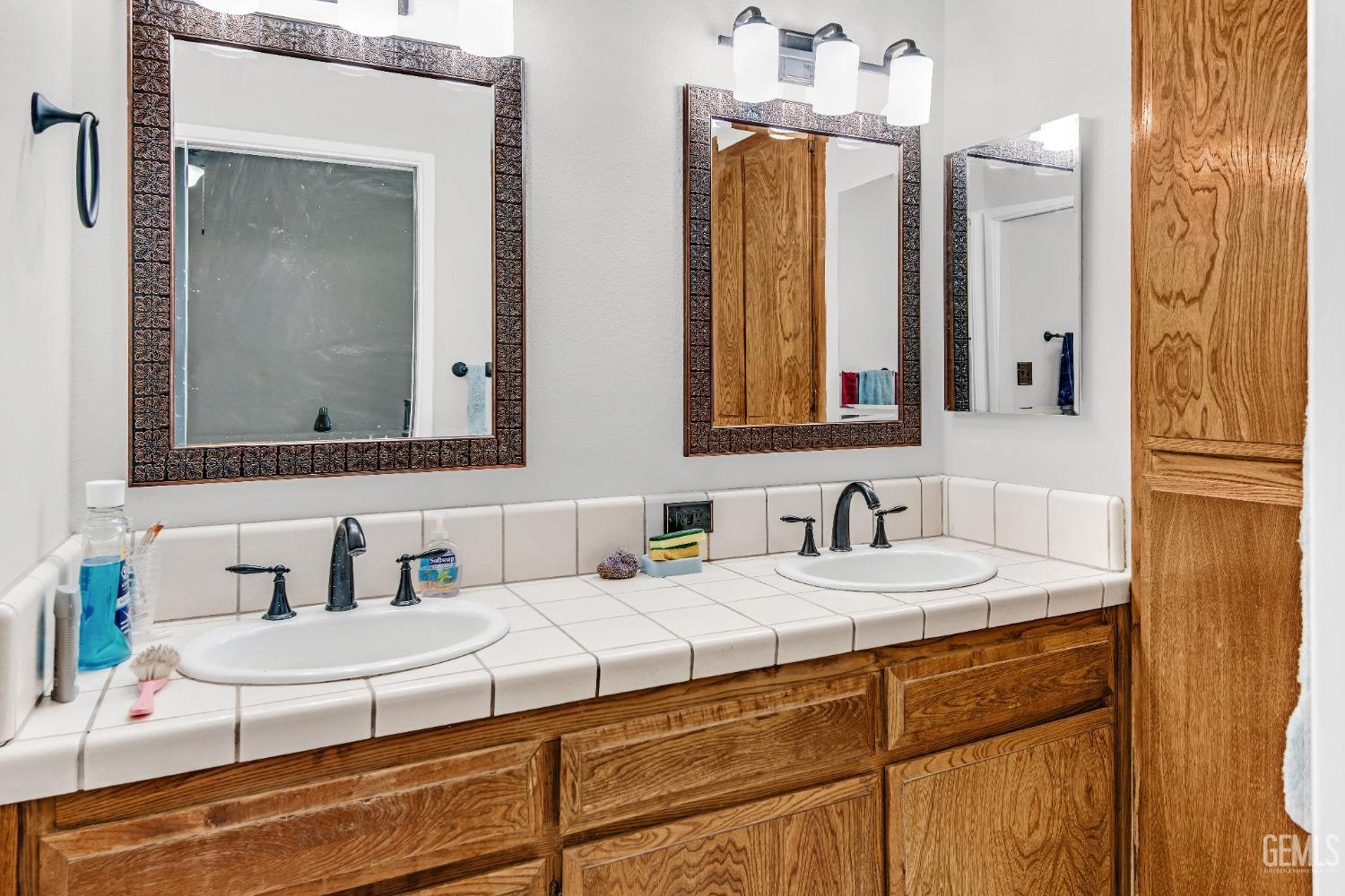 Undisclosed Address Bakersfield, CA 93309 - Photo 28 of 38 a bathroom with a sink and a mirror