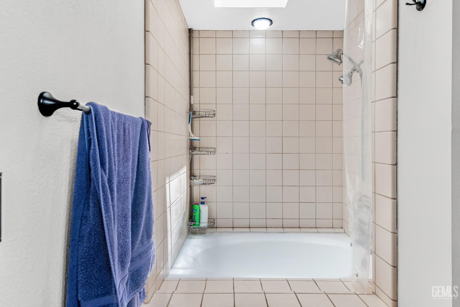 Undisclosed Address Bakersfield, CA 93309 - Photo 29 of 38 a bathroom with a shower and a tub