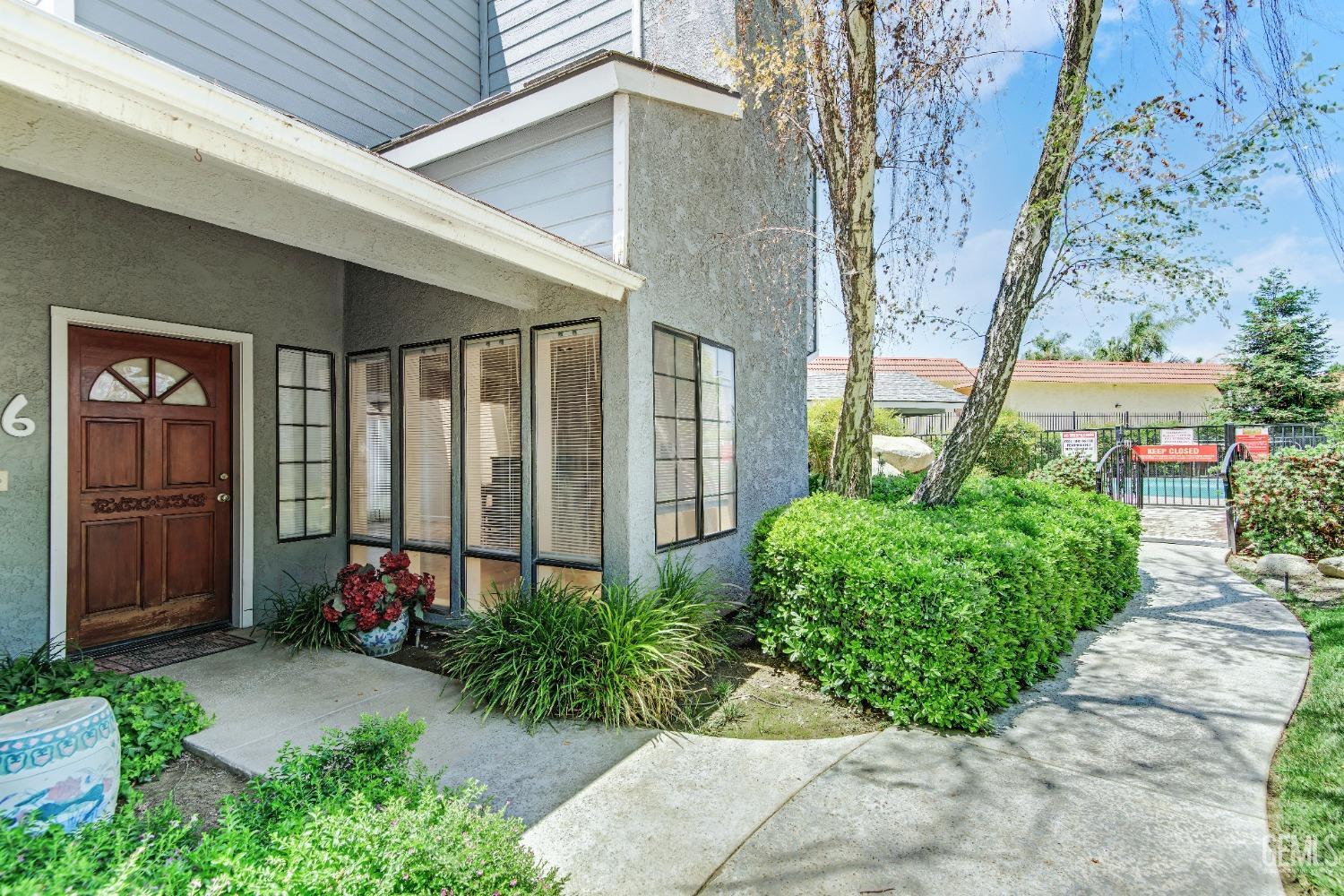 Undisclosed Address Bakersfield, CA 93309 - Photo 3 of 38 a front view of a house with garden