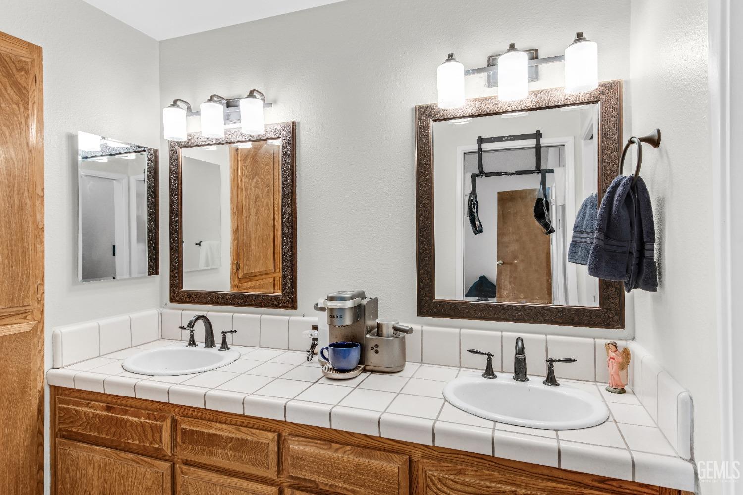Undisclosed Address Bakersfield, CA 93309 - Photo 32 of 38 a bathroom with double vanity sinks and a mirror