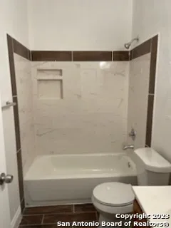a bathroom with a shower and a toilet