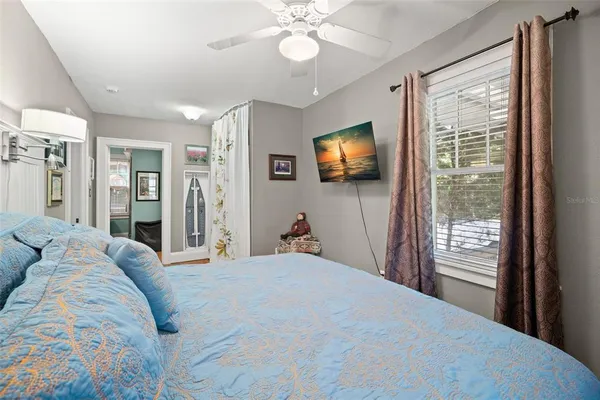 a bedroom with a bed and a flat screen tv