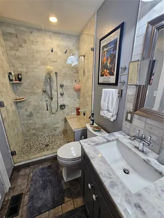a bathroom with a sink toilet and shower