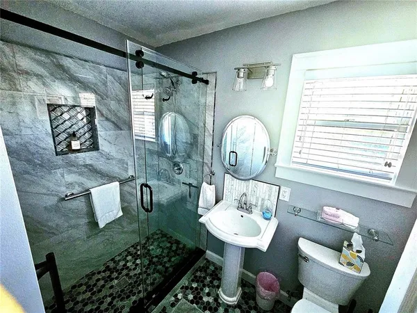 a bathroom with a sink toilet and shower