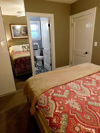 a bedroom with a bed and a mirror