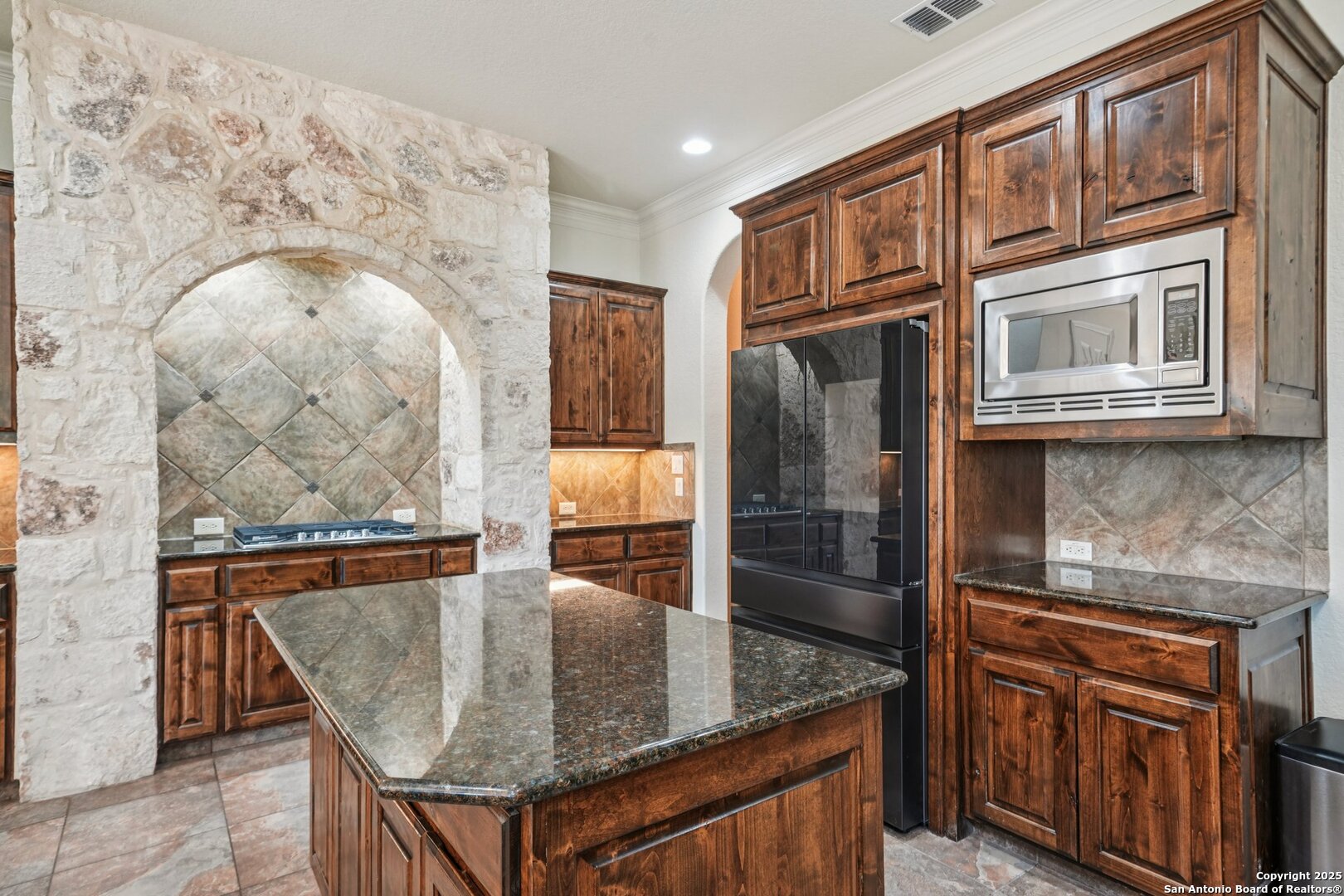 718 Ruidosa Downs Helotes, TX 78023 - Photo 10 of 50 view of kitchen island a sink microwave and refrigerator