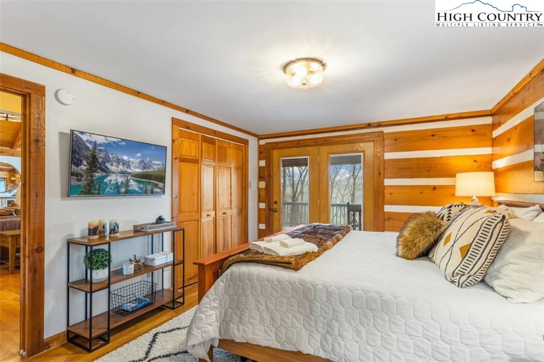 885 John Erwin Road Banner Elk, NC 28604 - Photo 14 of 50 a bedroom with a bed and glass window