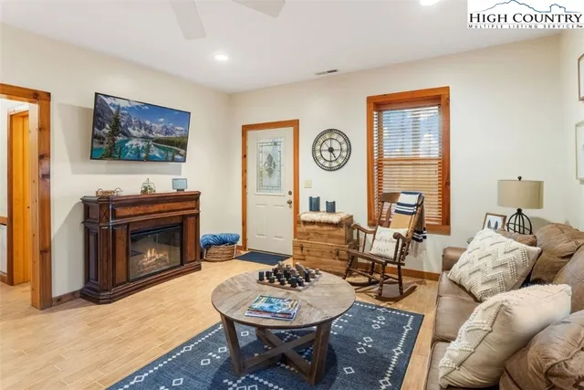 a living room with furniture a rug and a fireplace
