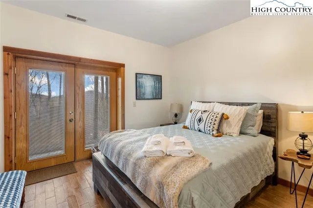 a bed sitting in a bedroom next to a bathroom