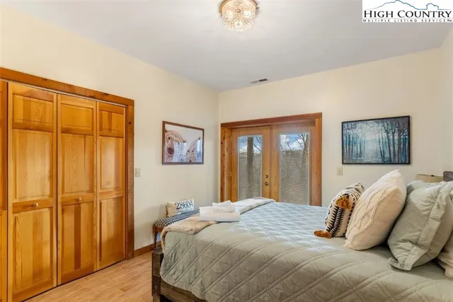 a bedroom with a large bed and a window