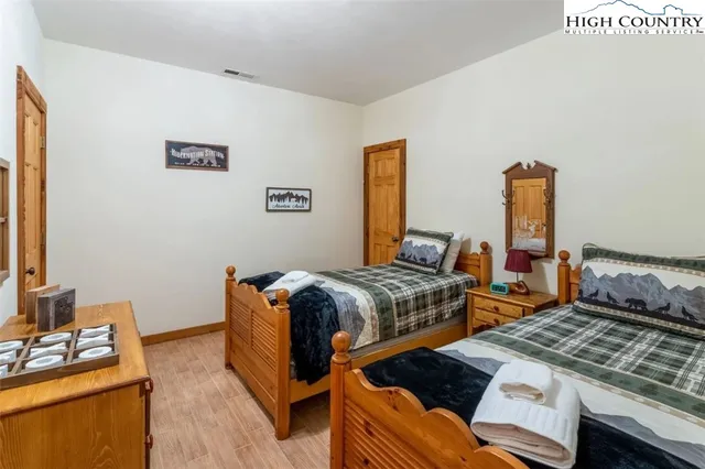 a bedroom with two beds and a dresser