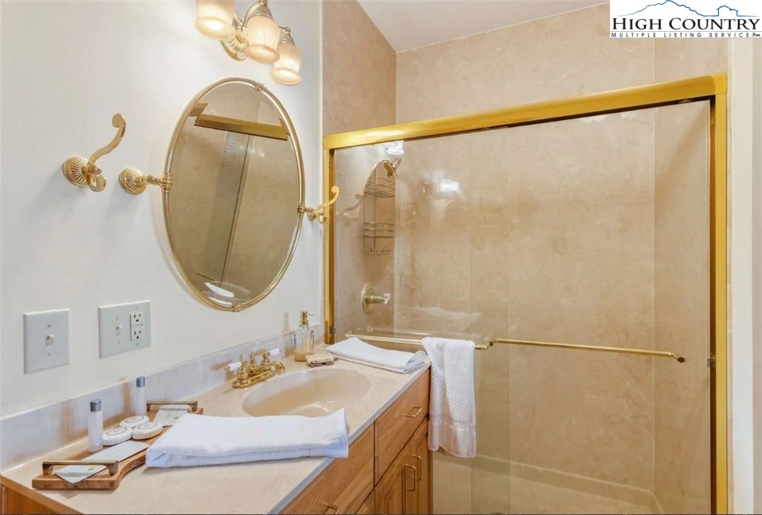 885 John Erwin Road Banner Elk, NC 28604 - Photo 26 of 50 a bathroom with a sink and a mirror