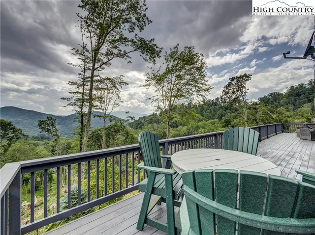 a view of a balcony with table and chairs