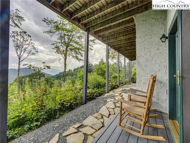 a view of balcony with wooden floor and outdoor seating
