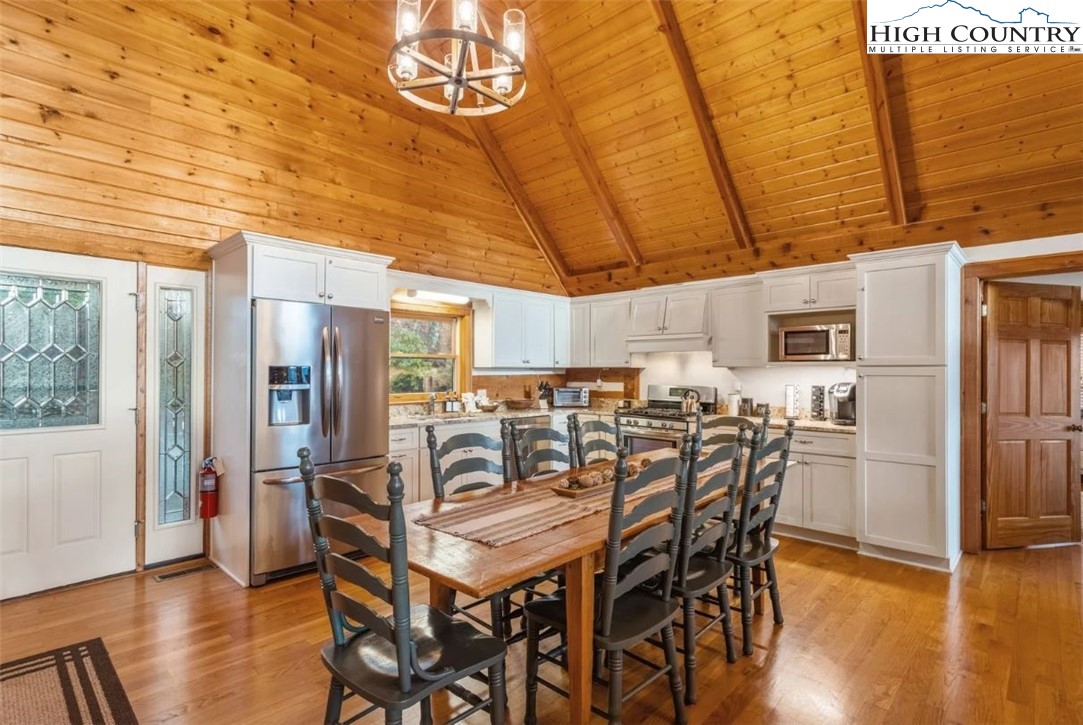 885 John Erwin Road Banner Elk, NC 28604 - Photo 8 of 50 a view of a dining room with furniture window and wooden floor