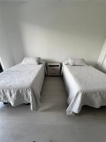 a bedroom with a bed and lamp