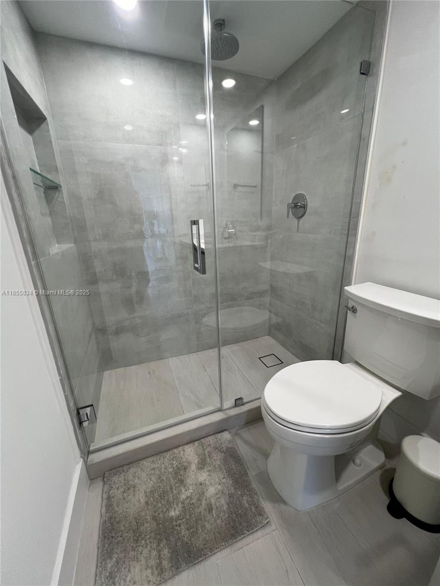 251 Crandon Boulevard, Unit 202 Key Biscayne, FL 33149 - Photo 13 of 24 a bathroom with a toilet and a shower