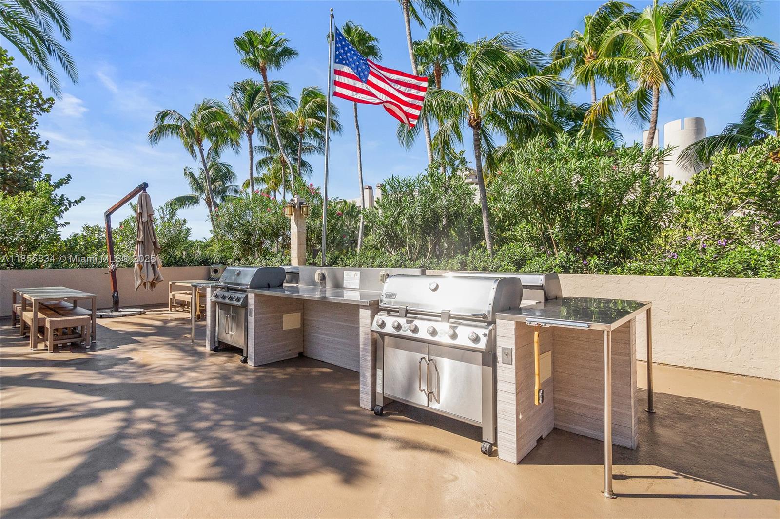 251 Crandon Boulevard, Unit 202 Key Biscayne, FL 33149 - Photo 15 of 24 a view of a dinning table and chairs in patio