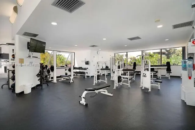 a view of a room with gym equipment and a large window