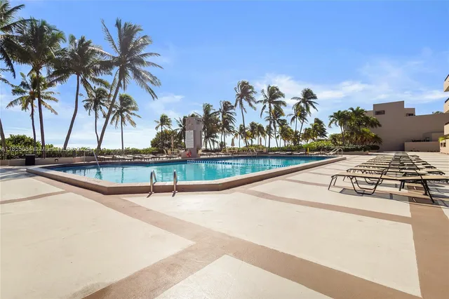a view of swimming pool with outdoor seating and plants