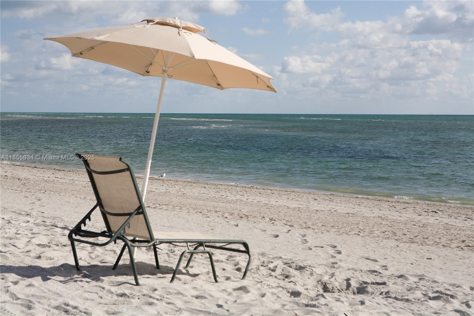 251 Crandon Boulevard, Unit 202 Key Biscayne, FL 33149 - Photo 24 of 24 a view of a lake with a table and chairs