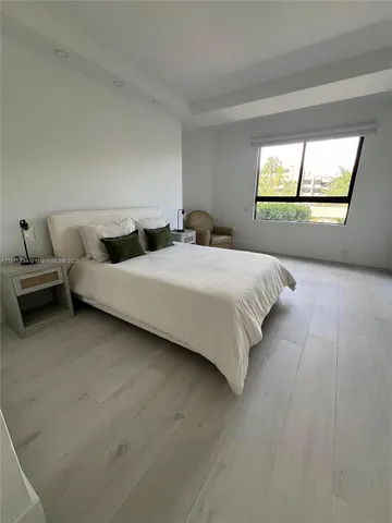a bedroom with a bed and a windows