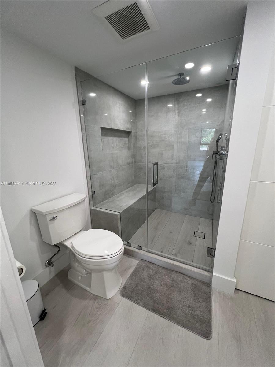 251 Crandon Boulevard, Unit 202 Key Biscayne, FL 33149 - Photo 8 of 24 a bathroom with a toilet and a shower