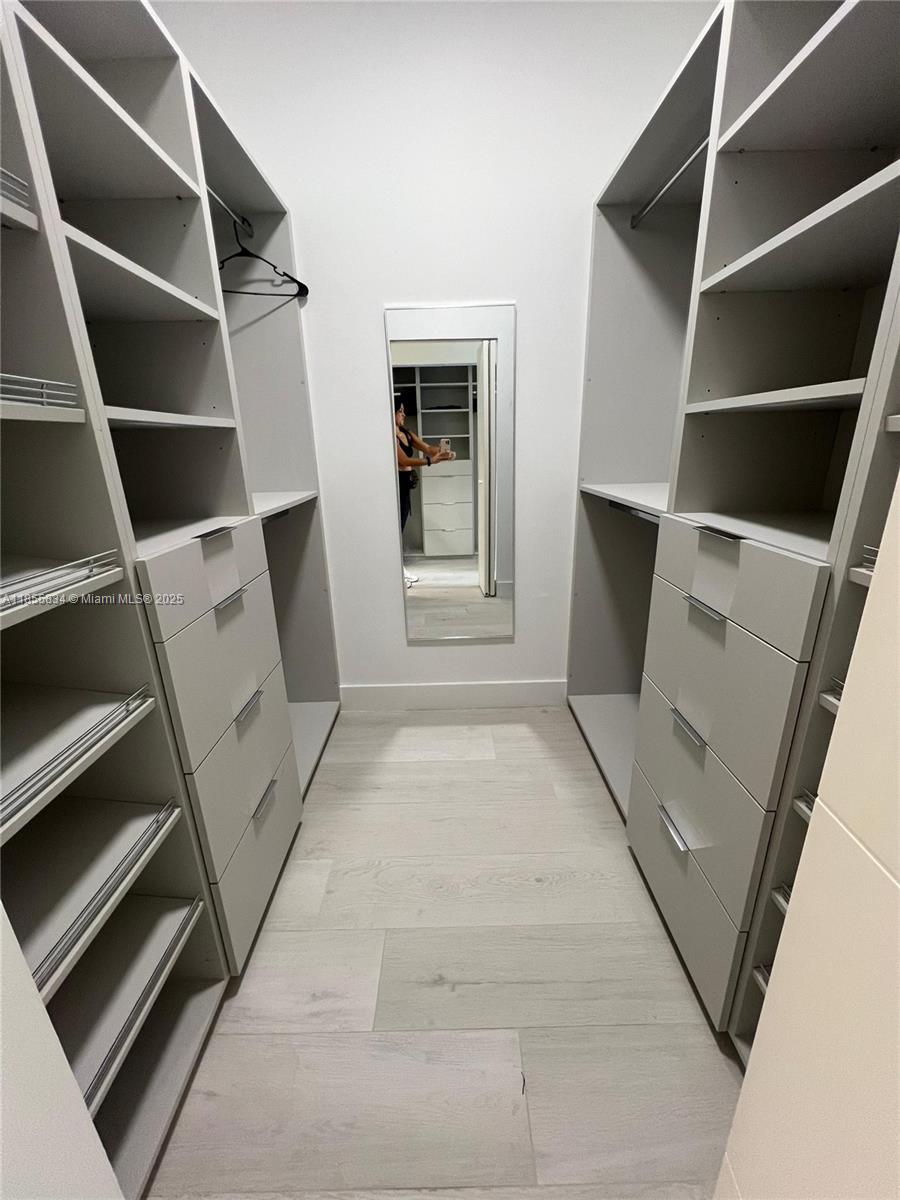 251 Crandon Boulevard, Unit 202 Key Biscayne, FL 33149 - Photo 9 of 24 a view of an empty room with a fireplace and cabinets