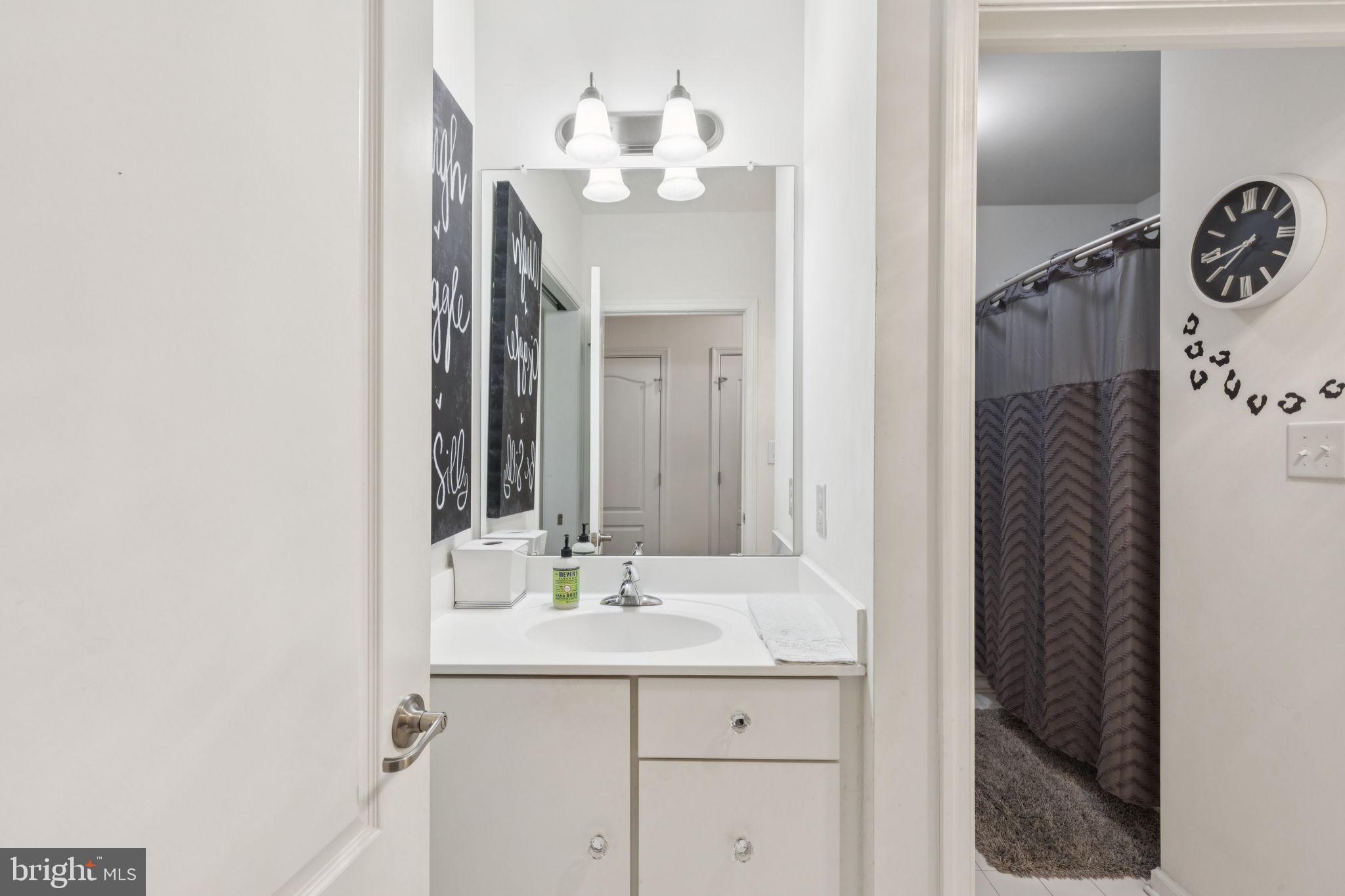 2303 Roma Drive Philadelphia, PA 19145 - Photo 41 of 80 a bathroom with a sink and a mirror