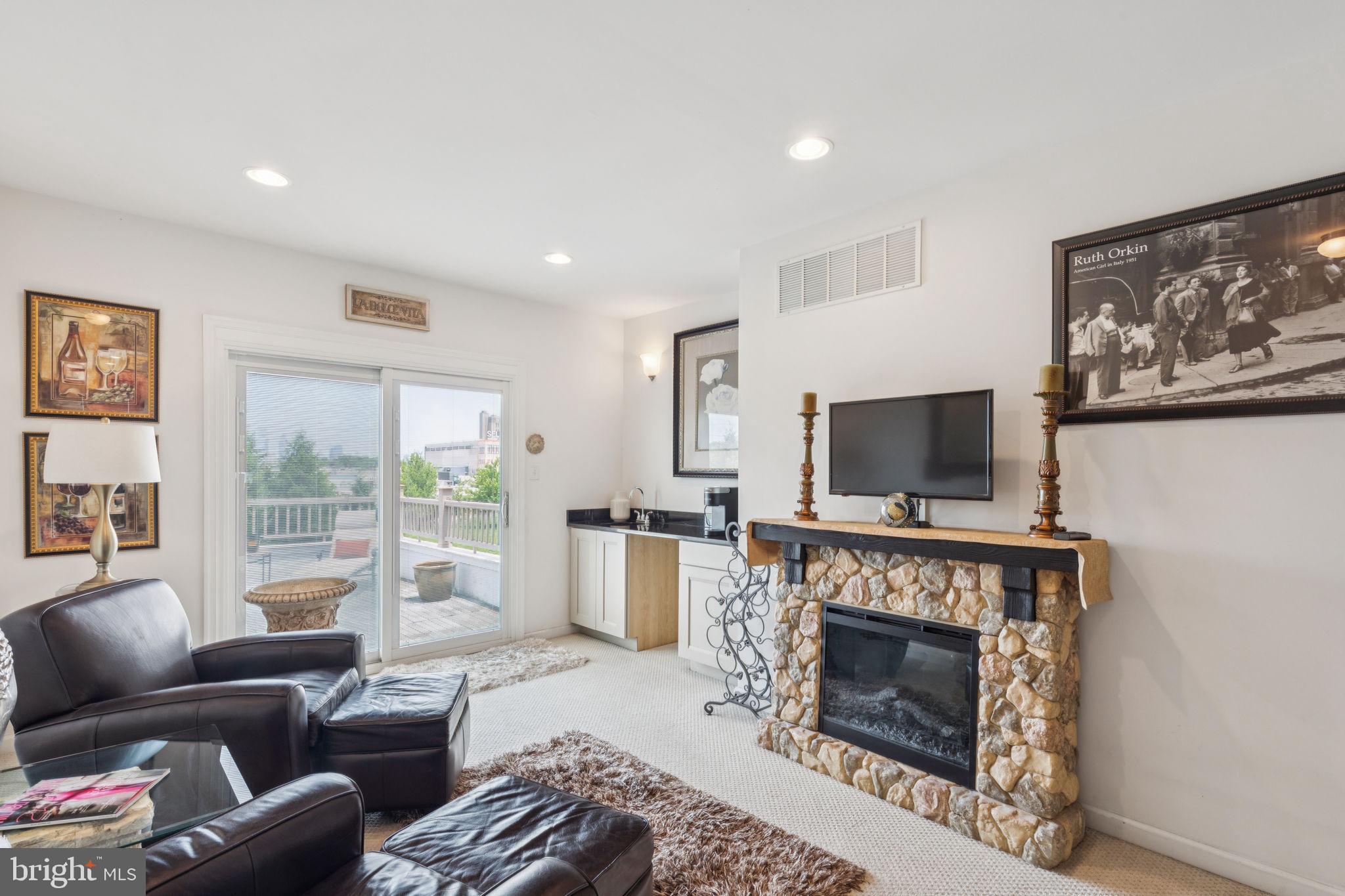 2303 Roma Drive Philadelphia, PA 19145 - Photo 52 of 80 a living room with furniture a flat screen tv and a fireplace