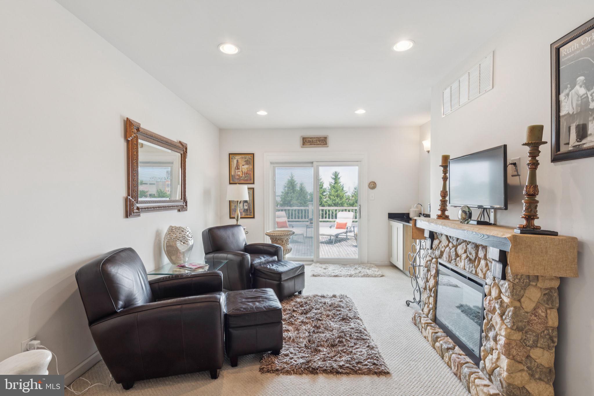 2303 Roma Drive Philadelphia, PA 19145 - Photo 53 of 80 a living room with furniture a flat screen tv and a fireplace