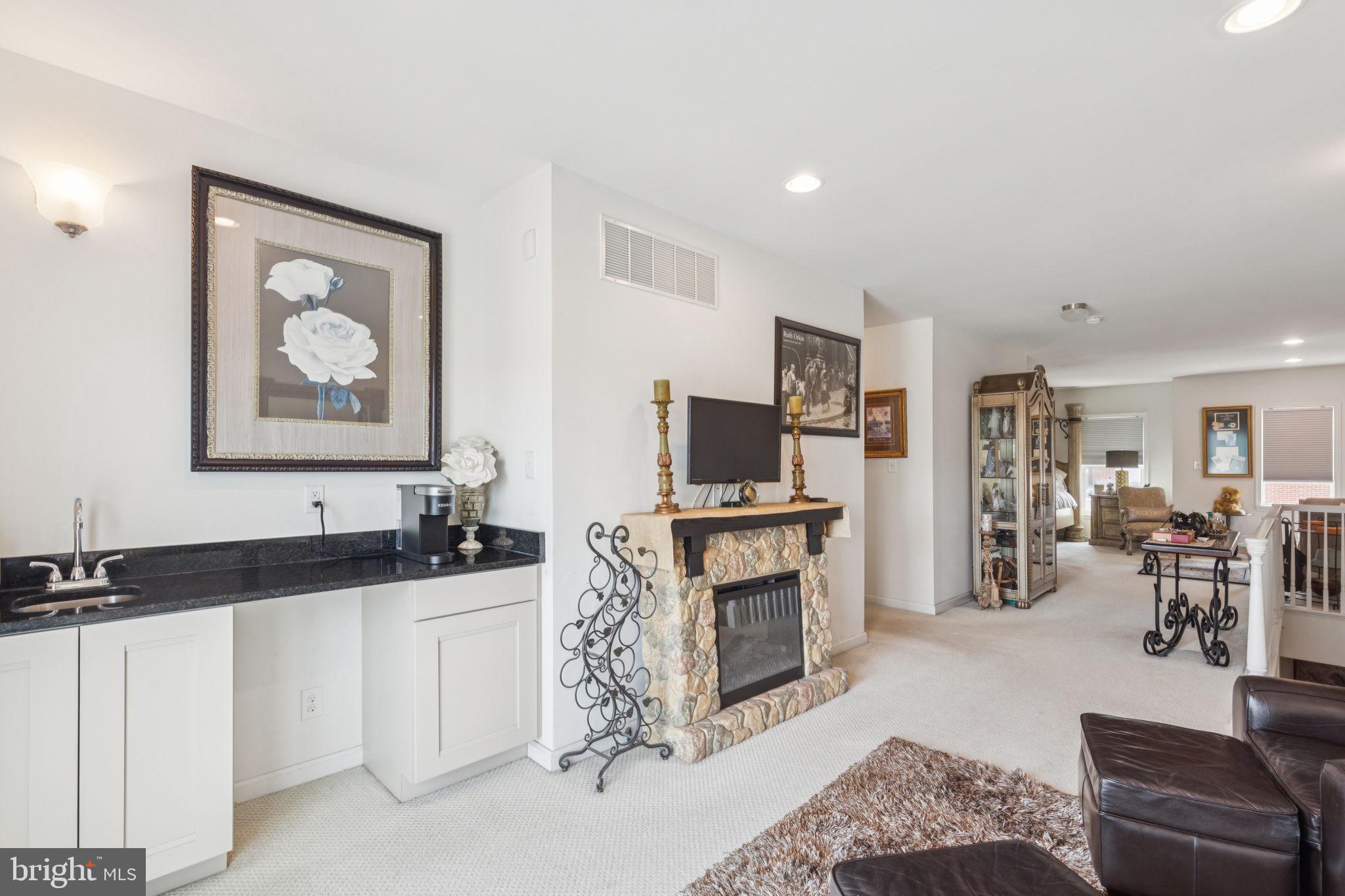 2303 Roma Drive Philadelphia, PA 19145 - Photo 67 of 80 a living room with furniture a fireplace and a flat screen tv