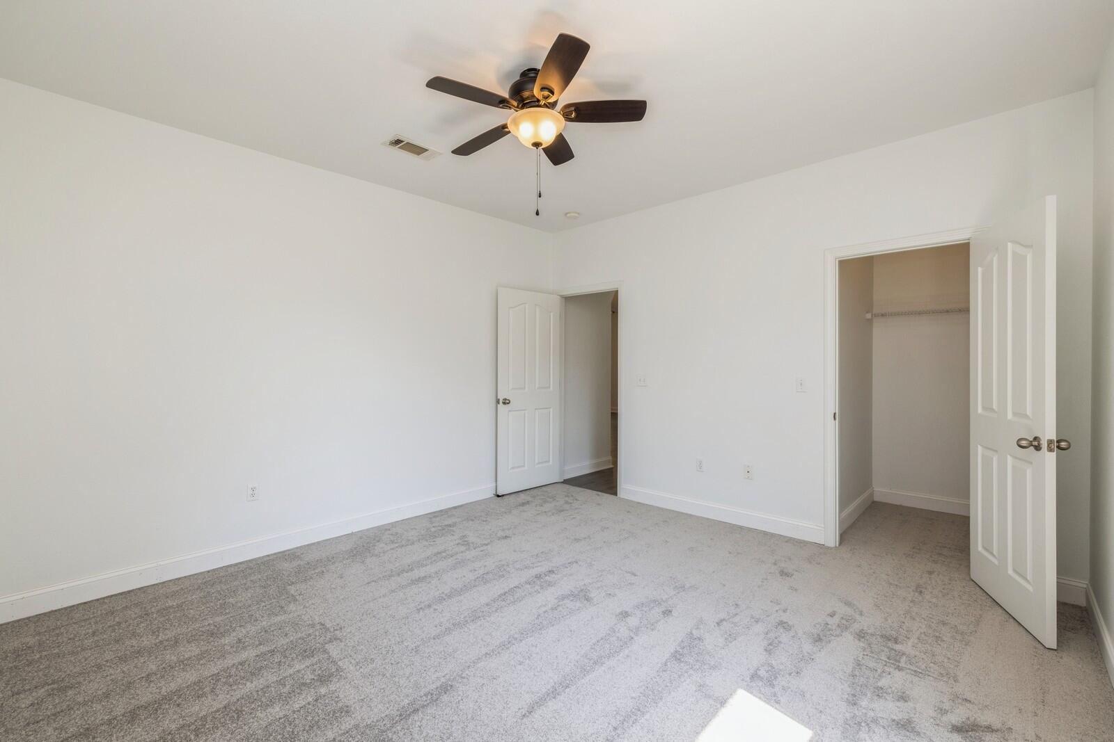 410 Wych Circle Crestview, FL 32536 - Photo 12 of 34 an empty room with a ceiling fan and a window