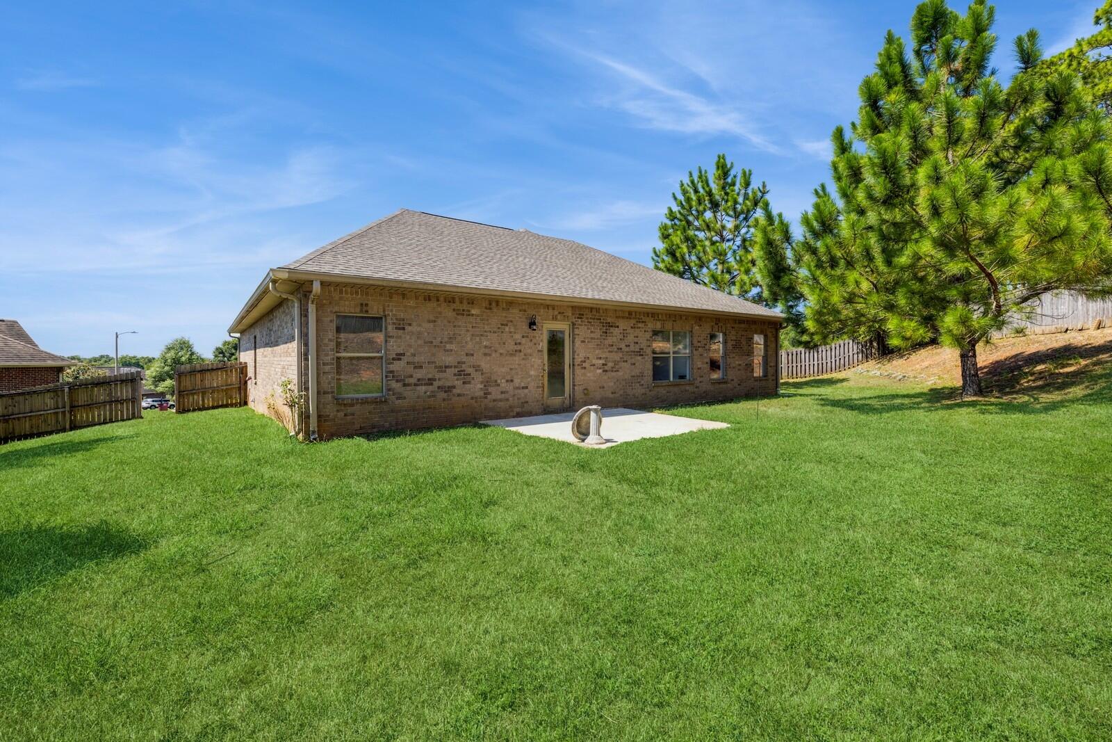 410 Wych Circle Crestview, FL 32536 - Photo 24 of 34 a front view of a house with a garden and yard