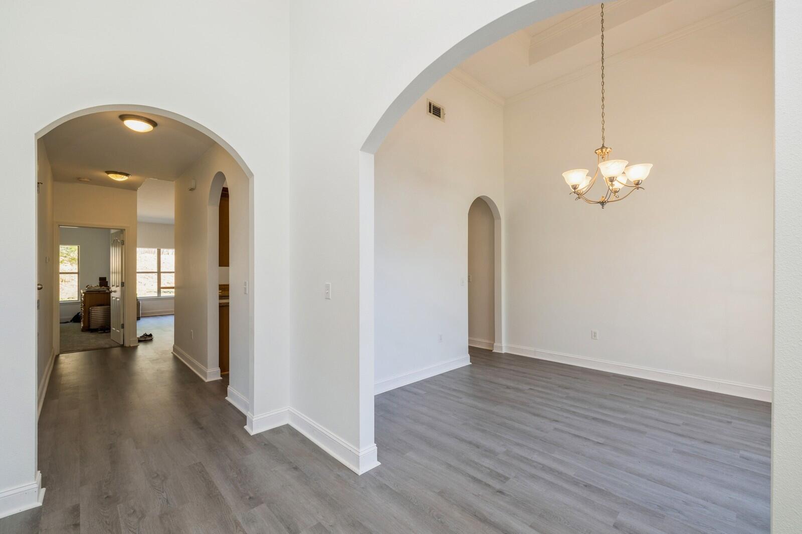 410 Wych Circle Crestview, FL 32536 - Photo 3 of 34 a view of a room with wooden floor and chandelier