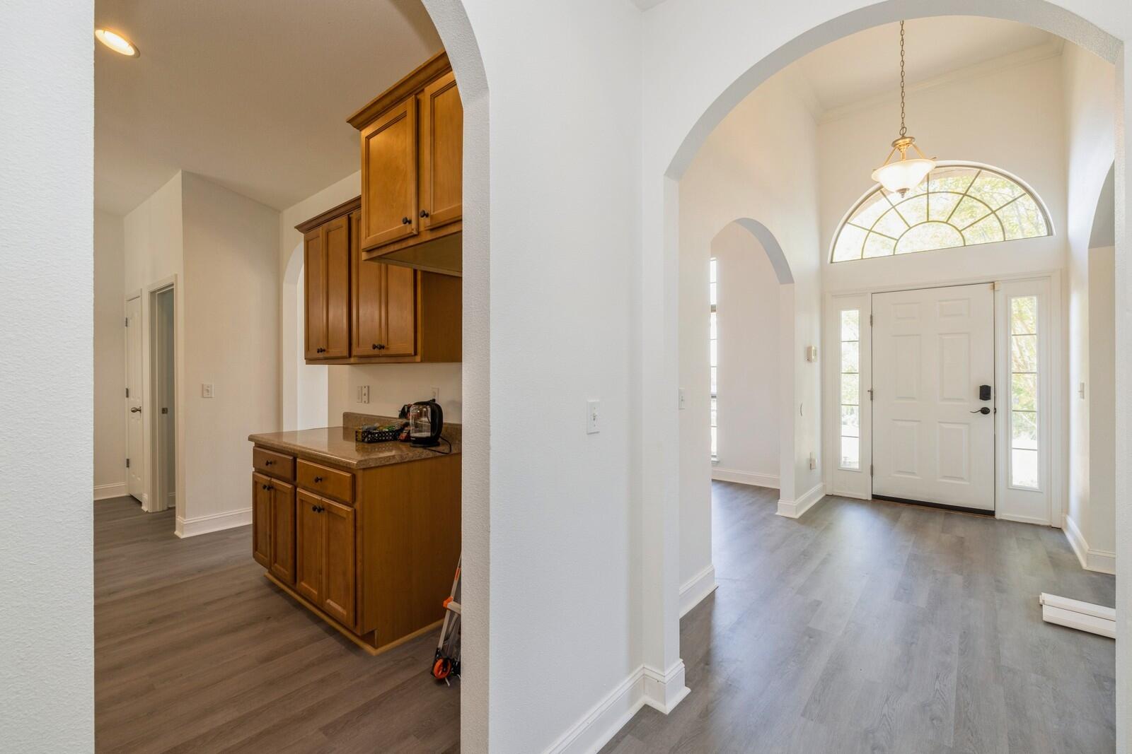 410 Wych Circle Crestview, FL 32536 - Photo 33 of 34 a view of a hallway with wooden floor and a bathroom