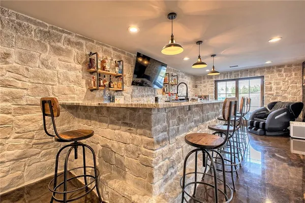 a room with furniture a rug and a chandelier